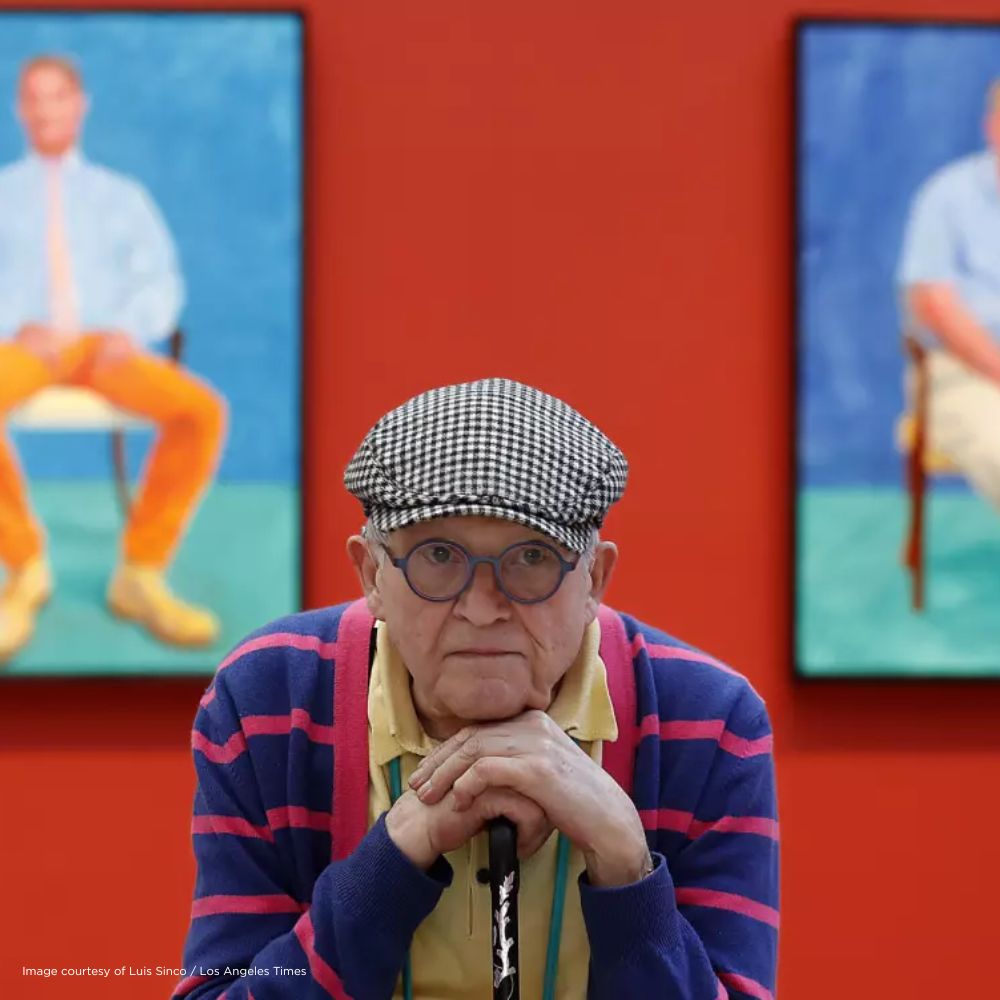 David Hockney at the Los Angeles County Museum of Art in front of two of his paintings