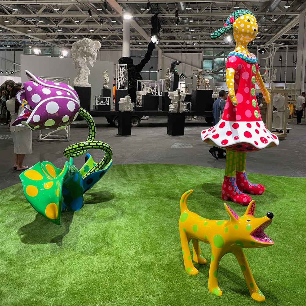 Contemporary art booth at Art Basel, featuring a diverse collection of paintings and sculptures.