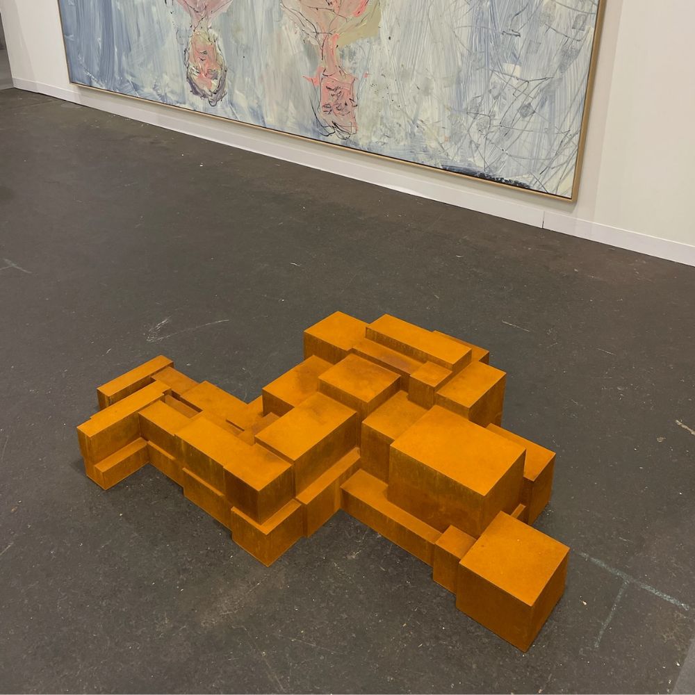 White Cube gallery booth at Art Basel 2025, featuring a bold sculpture by Antony Gormley and several paintings.