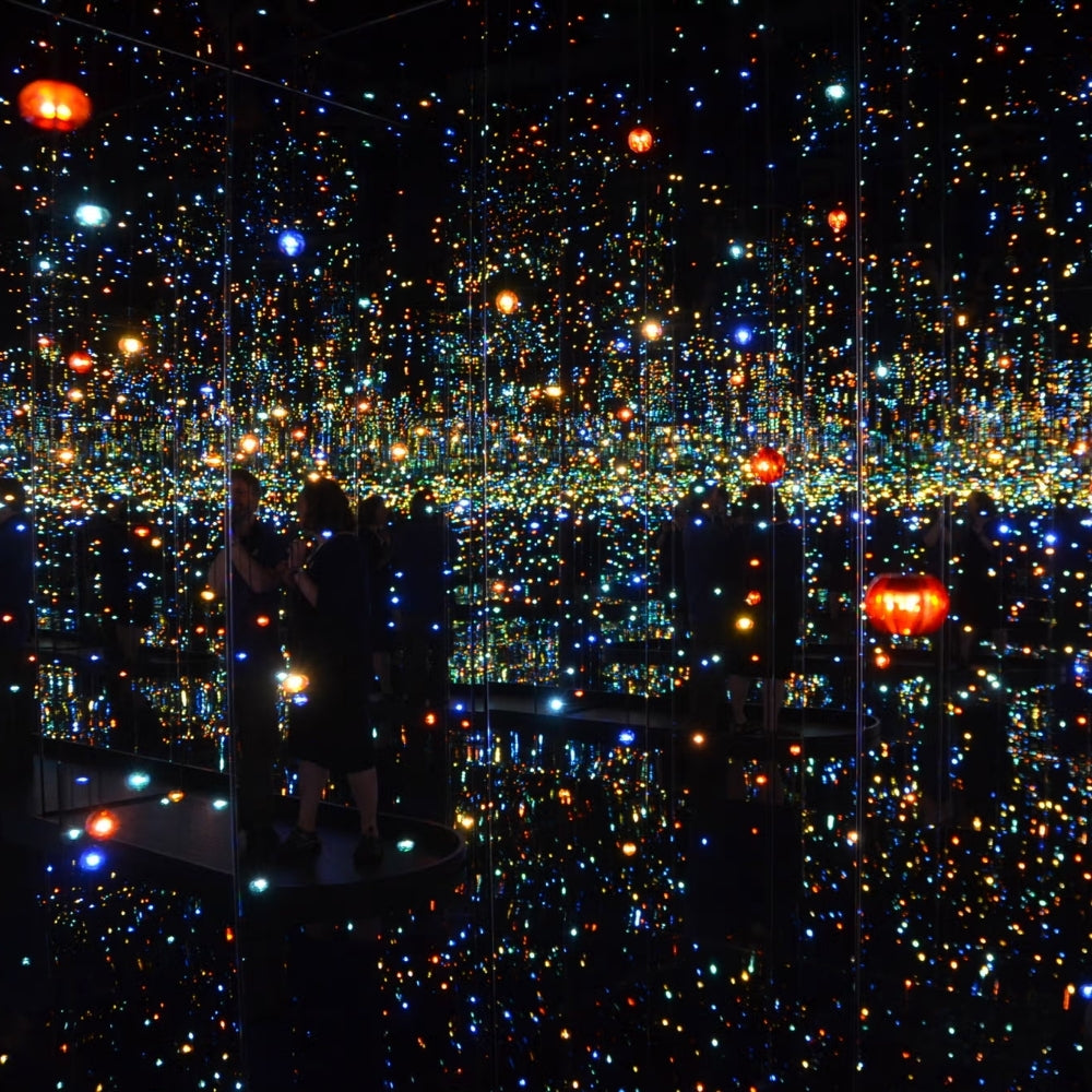 Visitor experiencing Yayoi Kusama’s immersive Infinity Mirror Room installation