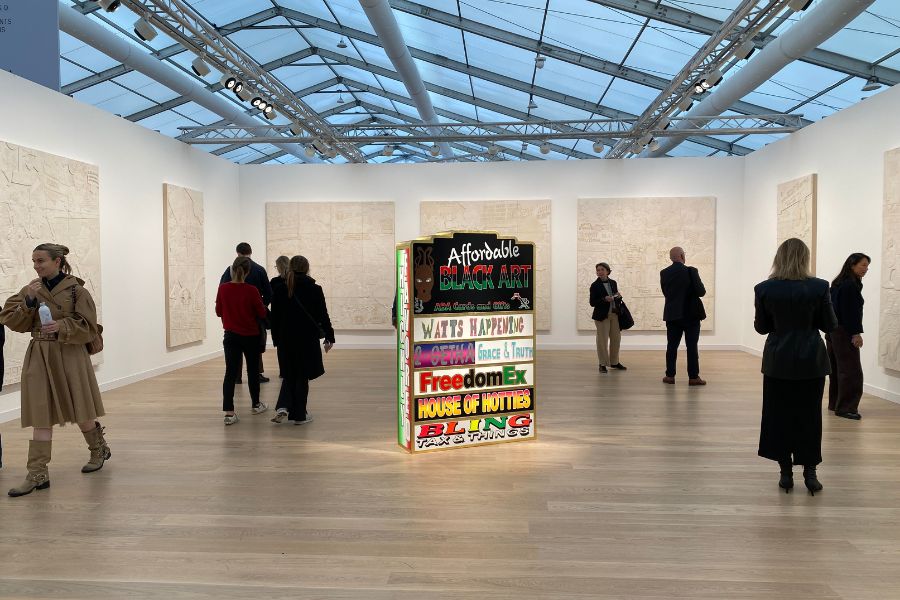 Art gallery with visitors and a prominent installation in the center. Frieze London Contemporary Art Fair