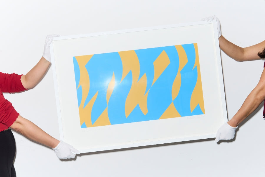 Specialist examining a contemporary artwork during an art valuation