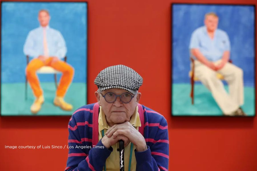 David Hockney at the Los Angeles County Museum of Art in front of two of his paintings