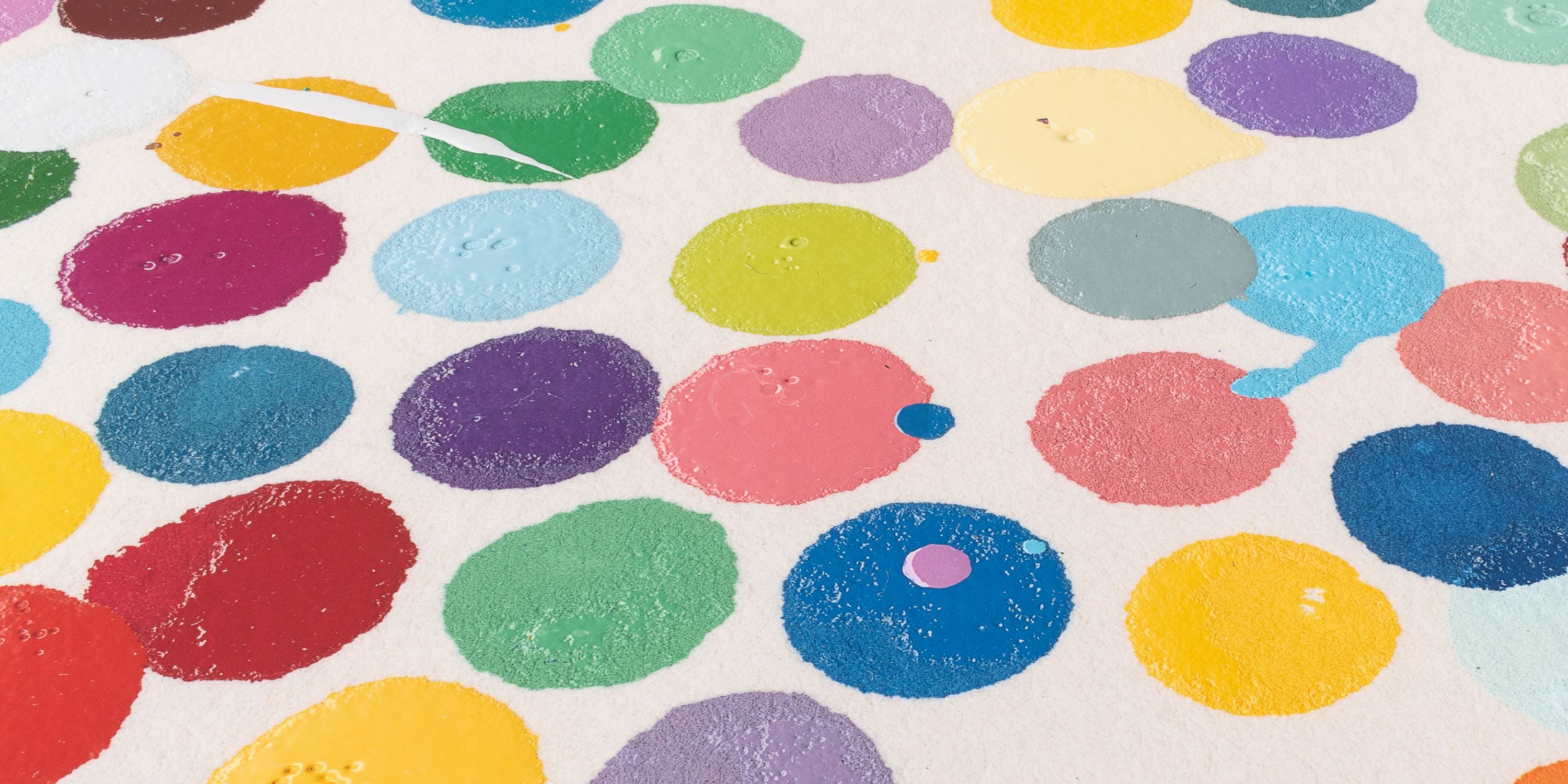 Colorful polka dot pattern on a textured surface Damien Hirst Spot Print