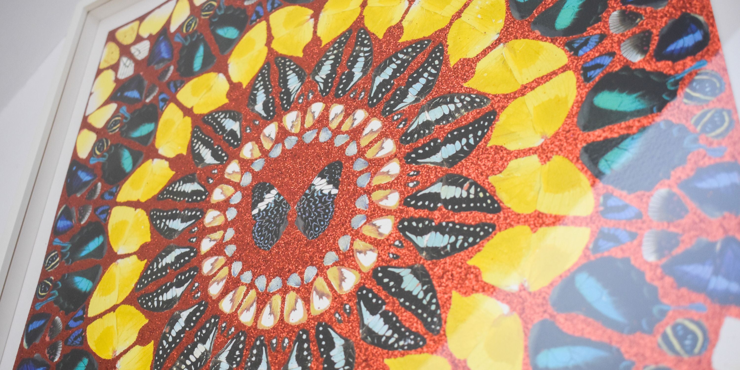 Colorful mosaic pattern with a central design on a textured surface damien hirst butterfly