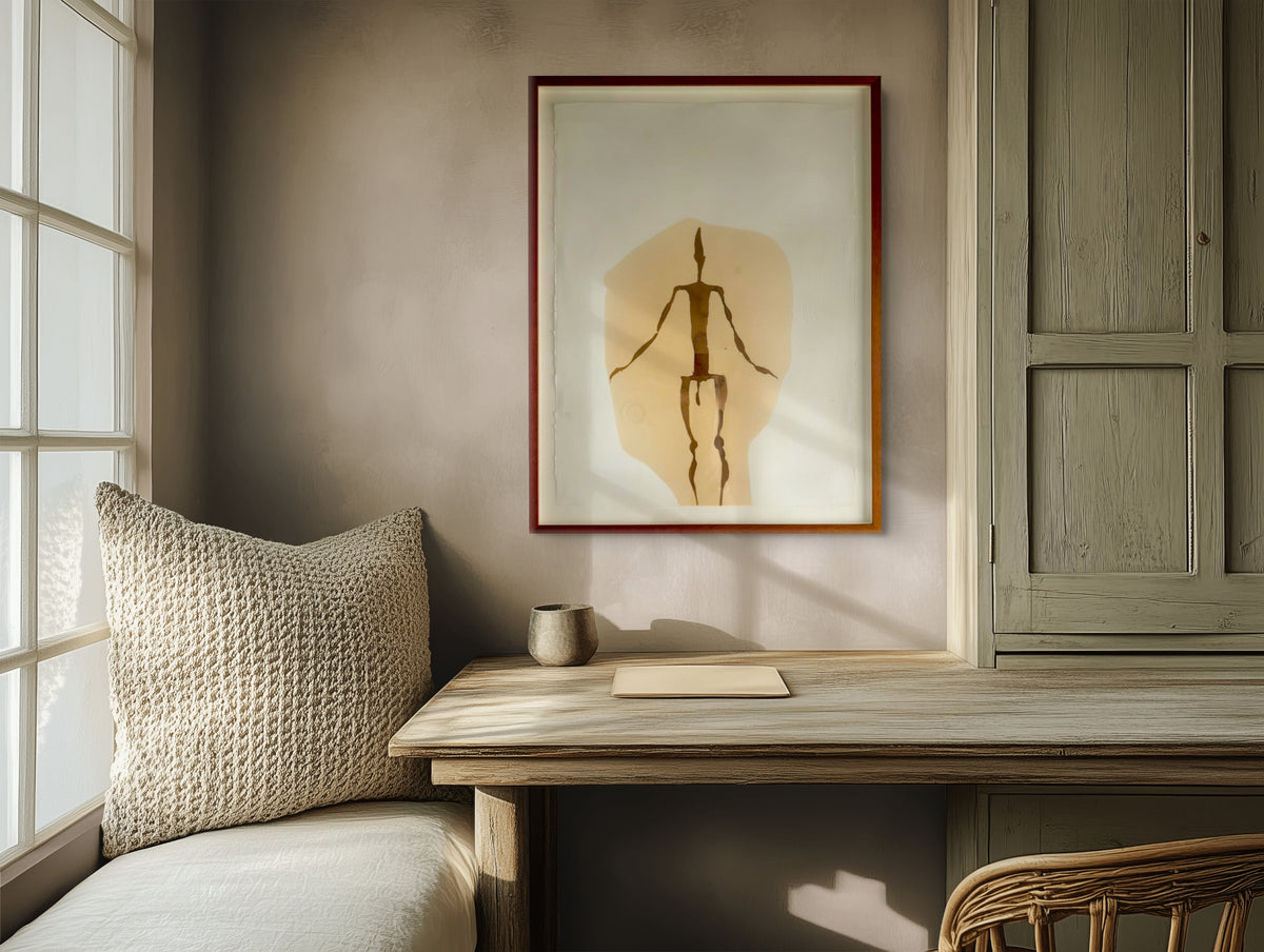 Framed contemporary artwork displayed against a textured neutral wall in a calm, naturally lit interior.