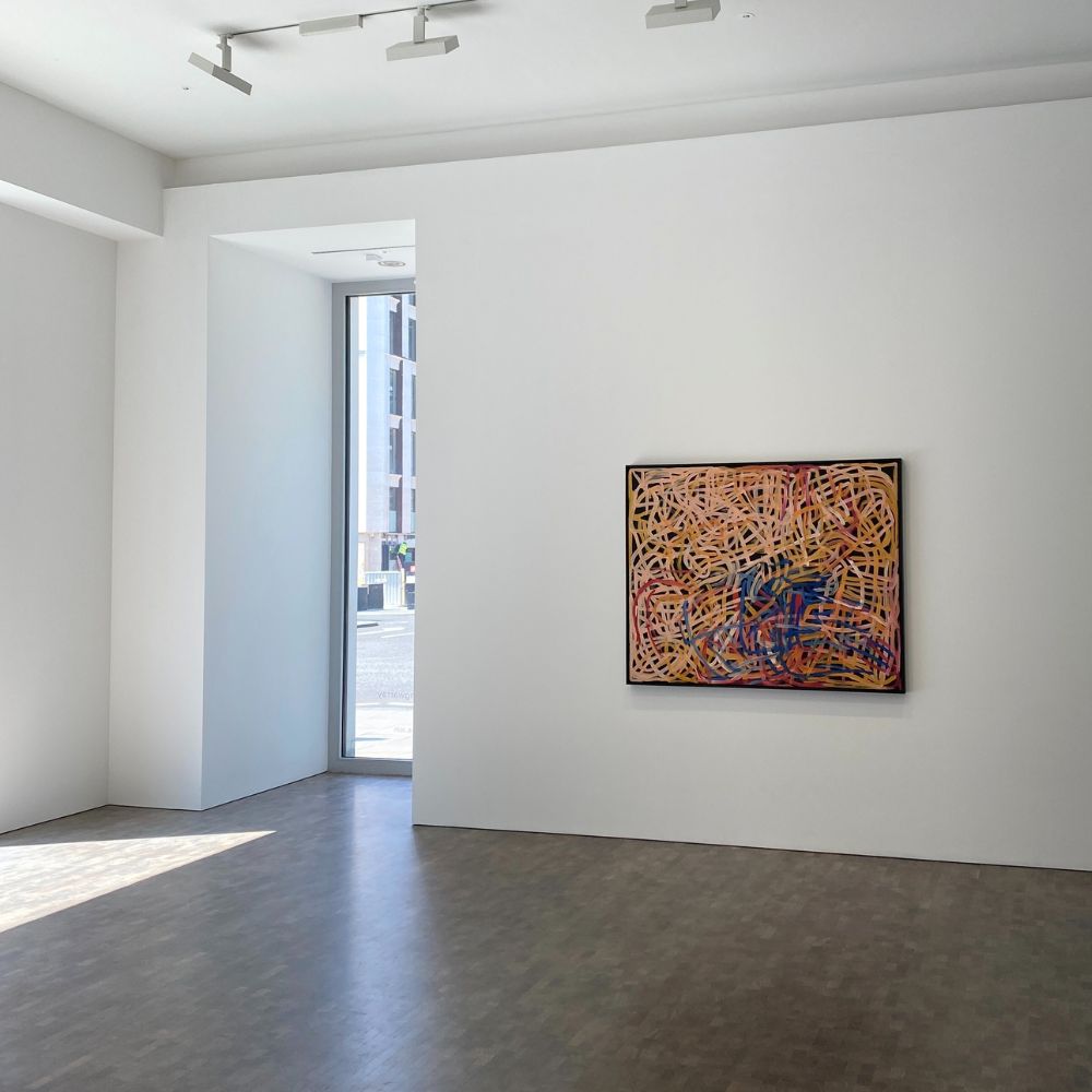 Modern art gallery with a single abstract painting on a white wall Emily Kam Kngwarray art exhibit at pace gallery london