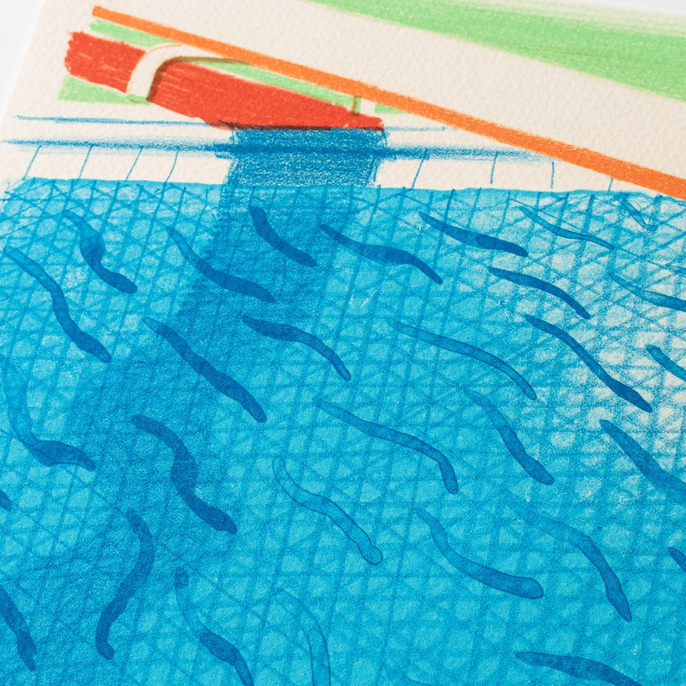 Paper Pools david hockney print series. A close-up of a printed or painted scene showing bright blue water with dark blue fish-like strokes, plus a strip of white, green, and orange along the top edge.