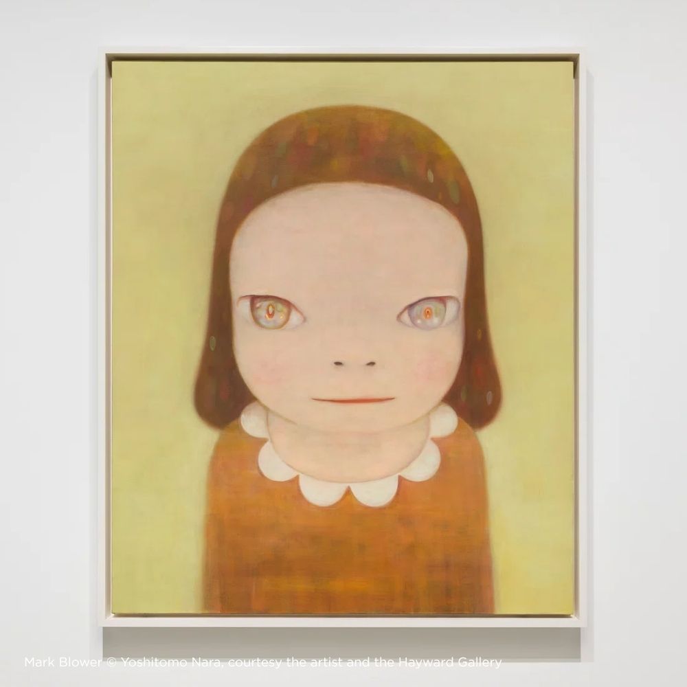 Framed artwork of a stylized portrait with a plain background Yoshitomo Nara at Hayward Gallery 
